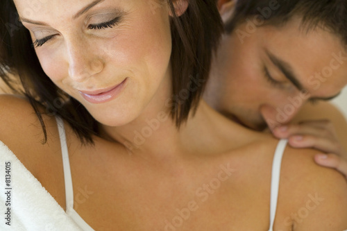 Photo: Young man kissing woman's shoulder, close-up Young man kissing woman's shoulder, close-up