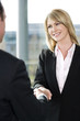 Businesswoman shaking hands with male client or colleague