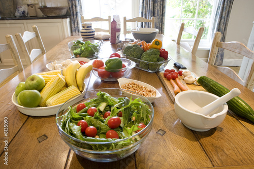 Photo: Salad, nuts, fruit, vegetables and pestle and mortar on dining table Salad, nuts, fruit, vegetables and pestle and mortar on dining table