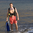 A male scuba diver returning to the shore