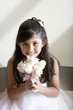 Photo: Girl (8-10), dressed in bridesmaid dress, holding wedding flowers, smiling, front view, portrait Girl (8-10), dressed in bridesmaid dress, holding wedding flowers, smiling, front view, portrait