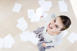 Woman smiling with dropped paperwork on the floor, aerial shot