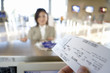Photo: Businesswoman checking in at airport, focus on boarding pass in check-in attendant’s hands in foreground, view from behind check-in desk Businesswoman checking in at airport, focus on boarding pass in check-in attendant’s hands in foreground, view from behind check-in desk