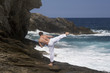 A man practicing Tai Chi by the sea