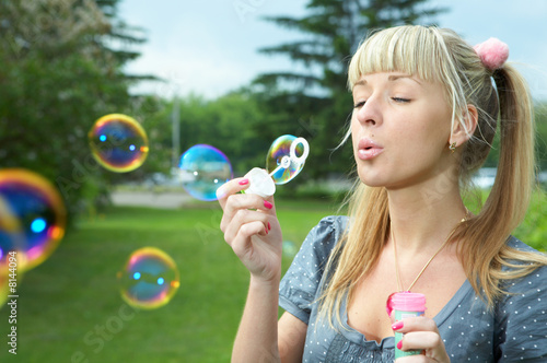 Foto: young girl makes soap bubble young girl makes soap bubble