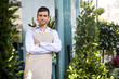Male florist standing at the entrance to his shop