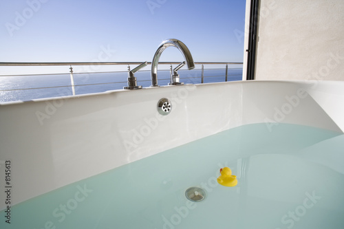 Photo: Bath with rubber duck on balcony by sea Bath with rubber duck on balcony by sea