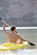 A man canoeing on a lake