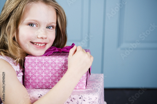 Photo: Young girl holding birthday presents Young girl holding birthday presents