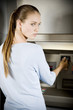 Portrait of a young woman using an ATM cash machine