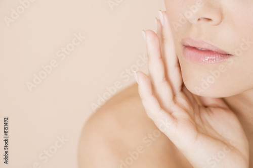 Photo: Close-up of woman holding her hand to her face Close-up of woman holding her hand to her face
