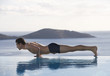 A man exercising by a pool