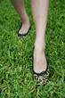 cropped image woman's feet walking on grass