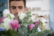Male florist amongst the flowers in his shop