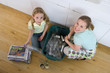 Photo: Mother and daughter (4-6) putting recycling into bin in kitchen, smiling, portrait, elevated view Mother and daughter (4-6) putting recycling into bin in kitchen, smiling, portrait, elevated view