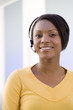 Young businesswoman in headset, smiling, portrait, close-up