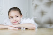 Portrait of a young girl with a feather boa in dressing up clothes