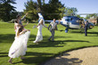 Photo: Bridesmaid, usher and flower girl (10-12) waving at senior bride and groom by helicopter Bridesmaid, usher and flower girl (10-12) waving at senior bride and groom by helicopter