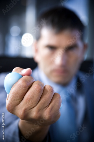Photo: Close up of a businessman's hand squeezing a stress toy Close up of a businessman's hand squeezing a stress toy