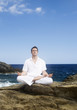 A man meditating by the sea