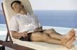 A man relaxing by a pool