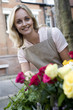 Woman tending to roses outside