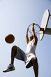 Foto: Portrait of young African jumping and hanging from a basketball ring Portrait of young African jumping and hanging from a basketball ring
