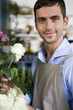 Male florist amongst the flowers in his shop