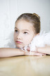 Portrait of a young girl with a feather boa in dressing up clothes