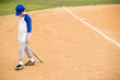 Young boy walking off baseball pitch
