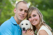 Happy Couple With Their Puppy Happy Couple With Their Puppy