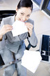Businesswoman licking and sealing an envelope