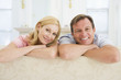 Couple relaxing in living room and smiling Couple relaxing in living room and smiling