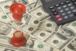 Sand-glass, money and calculator