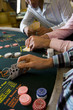 Young men gambling at poker table in casino, section