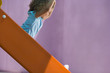 Girl (4-6) on slide, side view