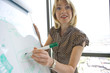Woman writing on whiteboard