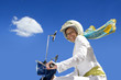 Woman on scooter, smiling, portrait, low angle view