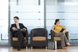 Businessman and woman waiting in lobby