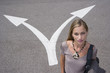 Young woman by arrows on road, portrait, elevated view