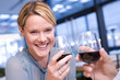 Couple proposing toast in restaurant, woman smiling at man