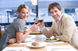 Couple proposing toast in restaurant, smiling, portrait