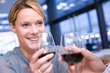 Couple proposing toast in restaurant, woman smiling at man