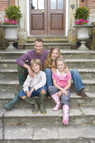 Photo: Family of four on steps, portrait Family of four on steps, portrait
