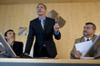 Businessman giving speech, flanked by colleagues