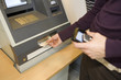 A man withdrawing money from an ATM machine.