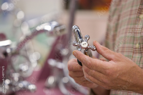 Photo: Man shopping in hardware store, close-up of hands Man shopping in hardware store, close-up of hands