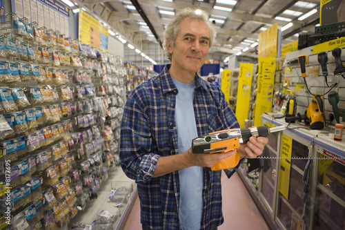 Photo: Man shopping in hardware store, portrait Man shopping in hardware store, portrait