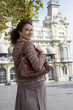 Woman standing outdoors in urban setting