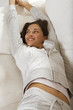 A woman stretching on a couch.